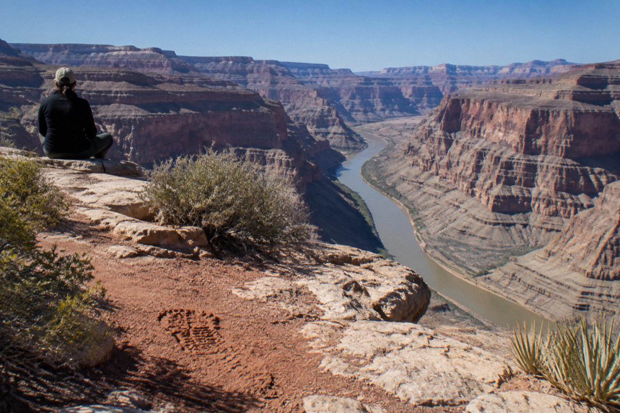 Canyon walls rising above the Colorado River at the Grand Canyon West rim area under a clear sky