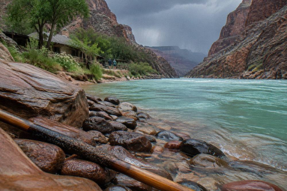 Calm turquoise water of the Colorado River between smooth sandstone canyon walls