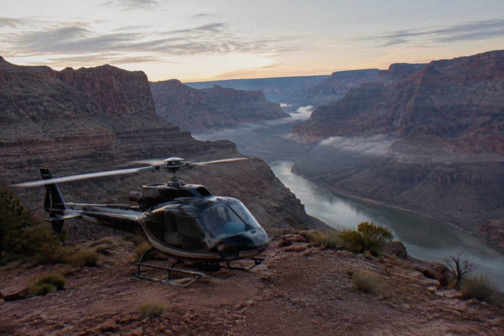 A helicopter parked on a canyon ledge above the Colorado River