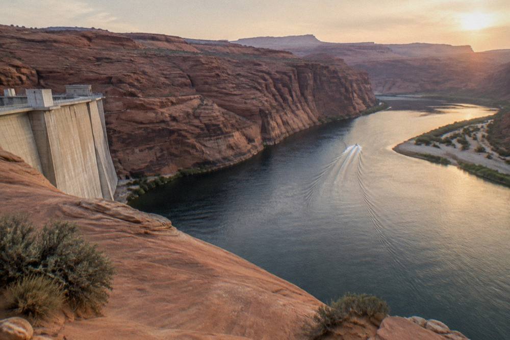 A calm river bend curving between smooth rock walls under open sky