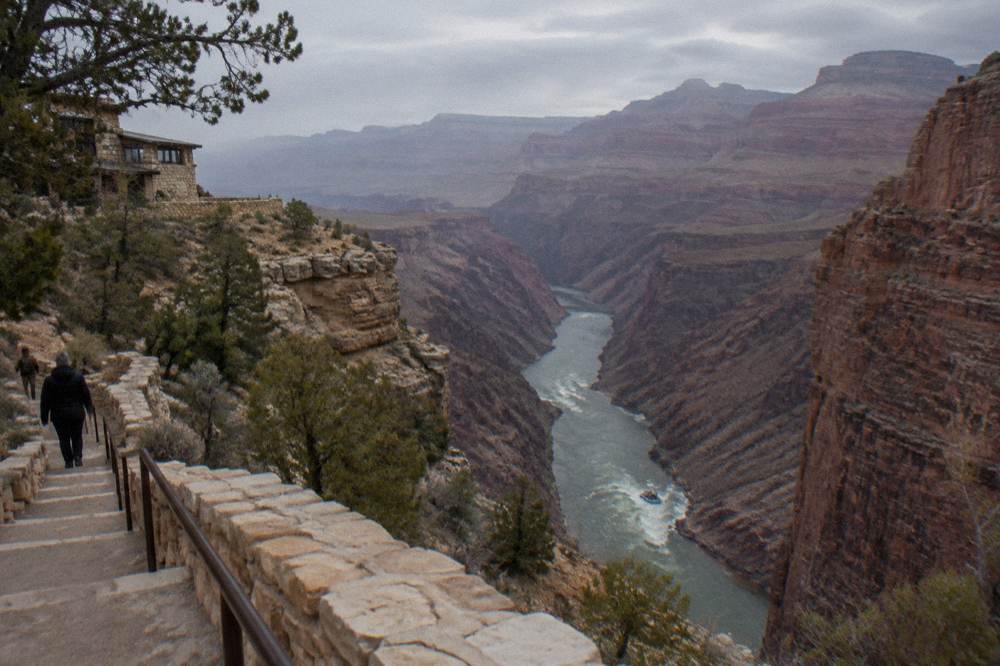 A motorized raft running a whitewater stretch of the Colorado River between canyon walls